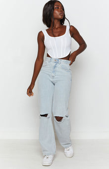 High-waisted light blue wide leg jeans with distressed ripped knees
