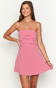 Front view of a red gingham mini dress with a square neckline and ruched bodice
