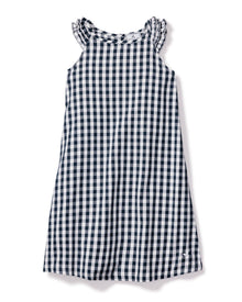 The Girls Twill Amelie Nightgown in Navy Gingham by Petite Plume is a sleeveless cotton dress with a navy and white check pattern. It has a round neck with subtle ruffle detailing for added charm.