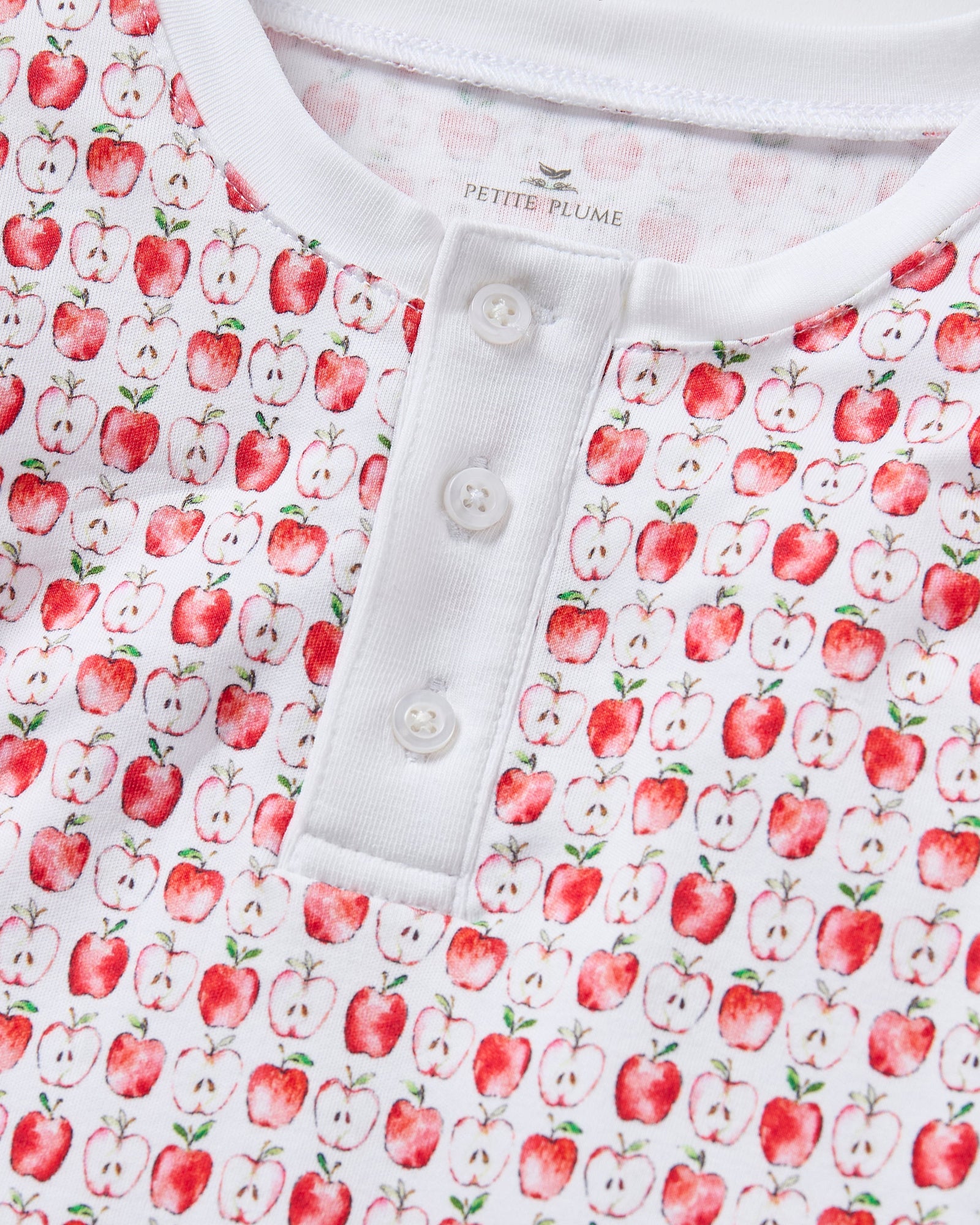 Kid's Pima Snug Fit Pajama Set in Autumn Orchards: two-piece set with long sleeves and pants, featuring a red flower pattern on a white background with solid white cuffs and neckline.