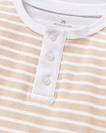 Kid's Pima Snug Fit Pajama Set in Camel Stripe features a beige and white striped long-sleeve top with white cuffs and button placket, plus matching pants with white ankle cuffs.