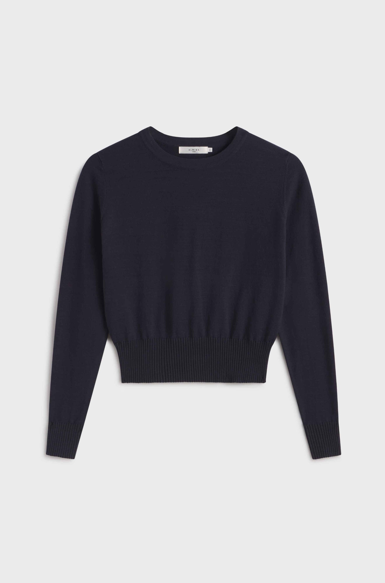 Navy long sleeve sweater on a light gray background