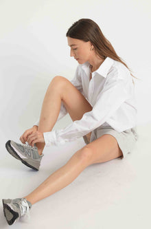 Woman wearing grey sweatshorts