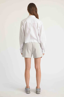 Woman wearing grey sweatshorts