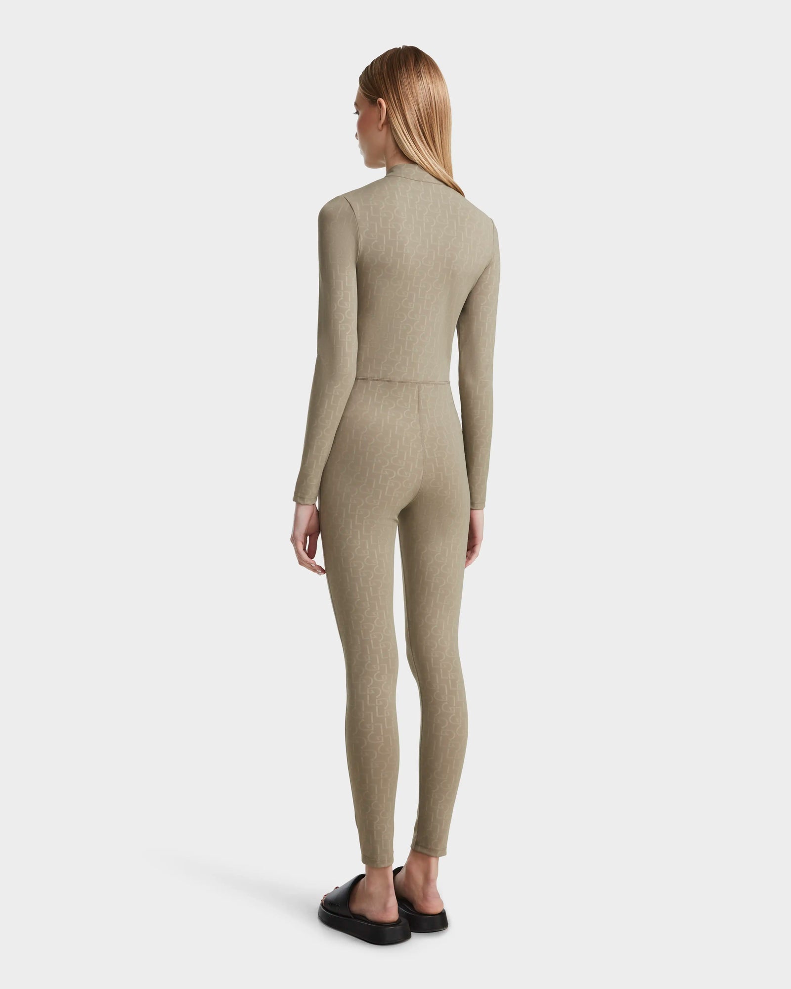 A woman models the SHANYA - 8523526 Cement Pattern bodysuit by Rudsak, highlighting its smooth stretch fabric that flatters her silhouette.