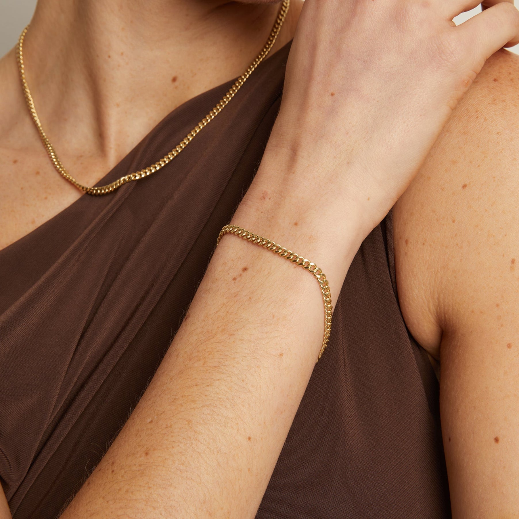 Model. Close up of woman wearing gold bracelet