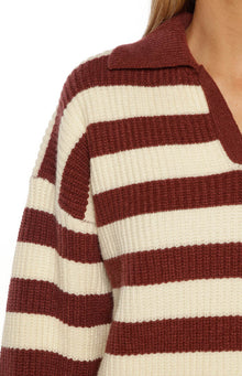 Close-up of the chunky knit texture of the burgundy and cream striped polo collar and shoulder