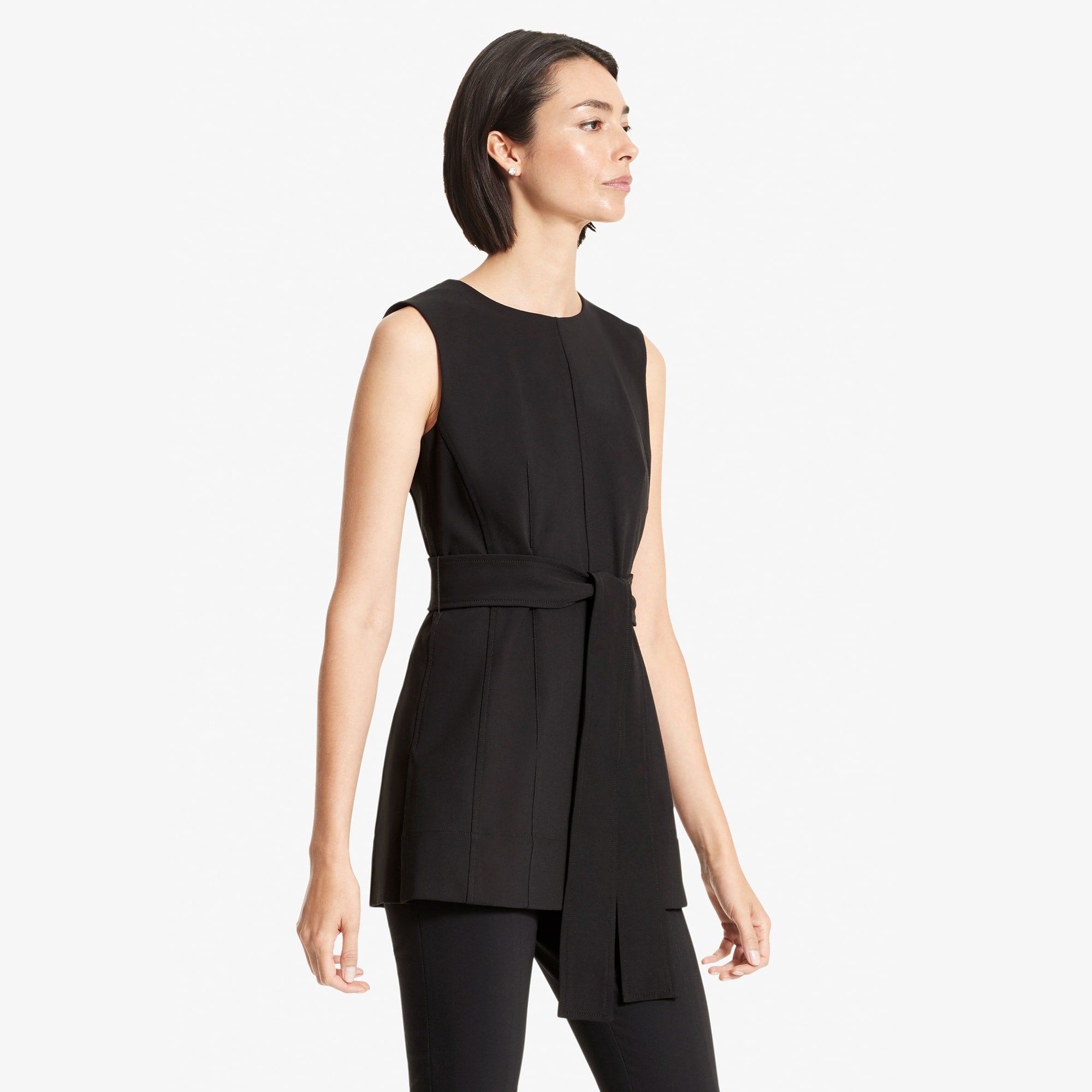 Side image of a woman standing wearing the Angelina top in Black | Exclude