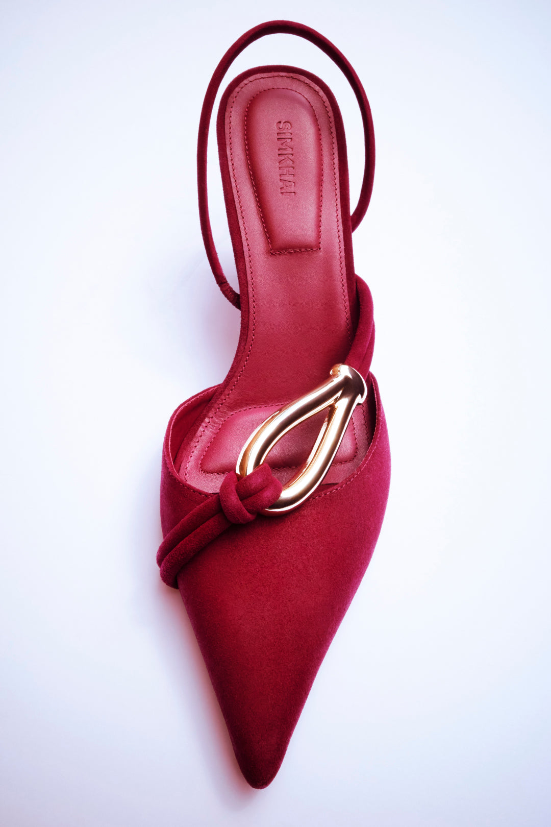 Burgundy suede slingback heel with knot detail at toe and gold hardware, shown from above.