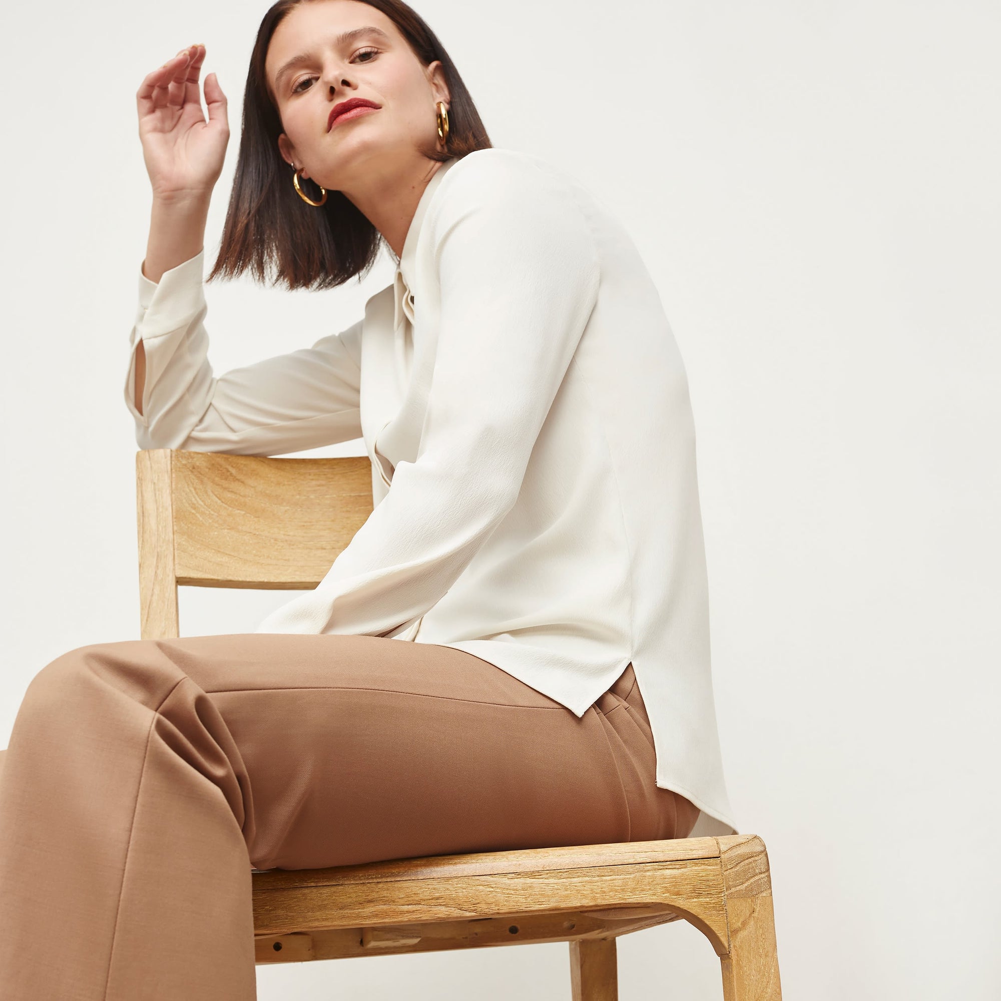 Side image of a woman standing wearing the Lagarde Shirt—Soft Wave in Alabaster | Exclude