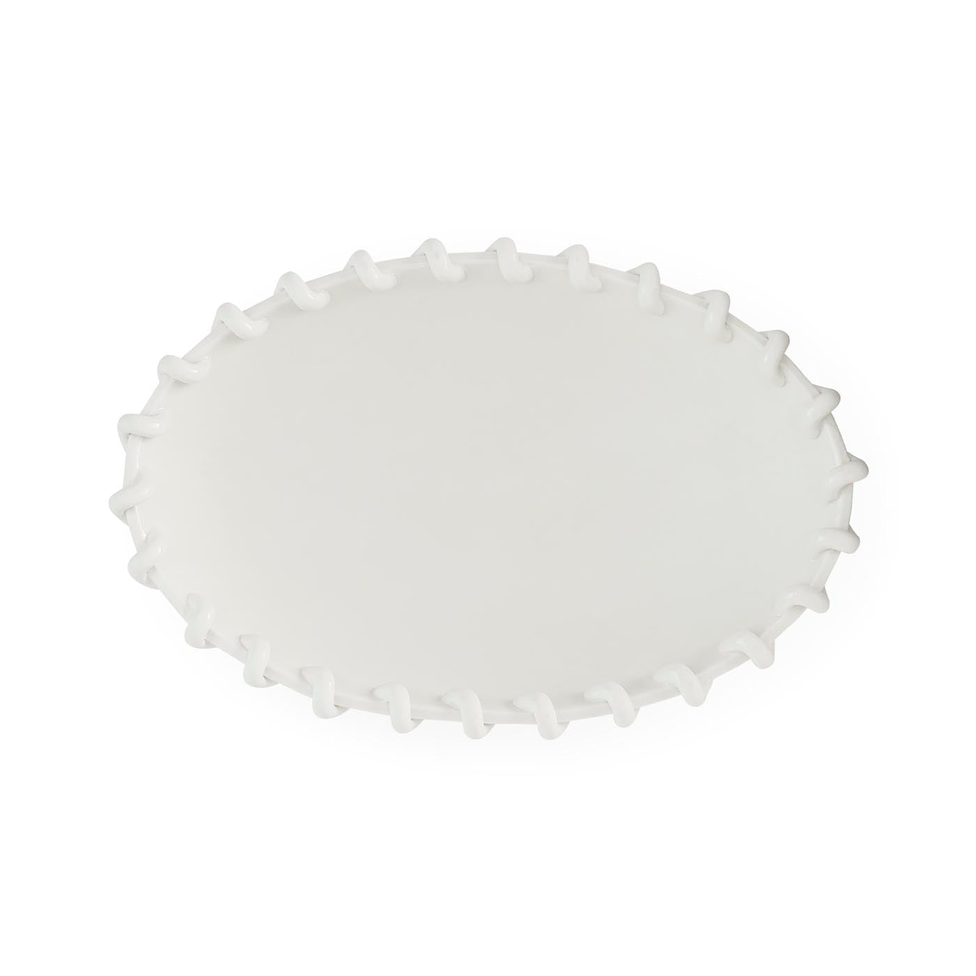 White scalloped-edge plate on a white background