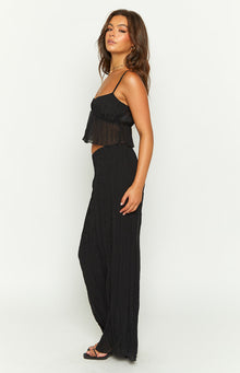 Side view of a black crinkled maxi skirt with a relaxed, flowy fit