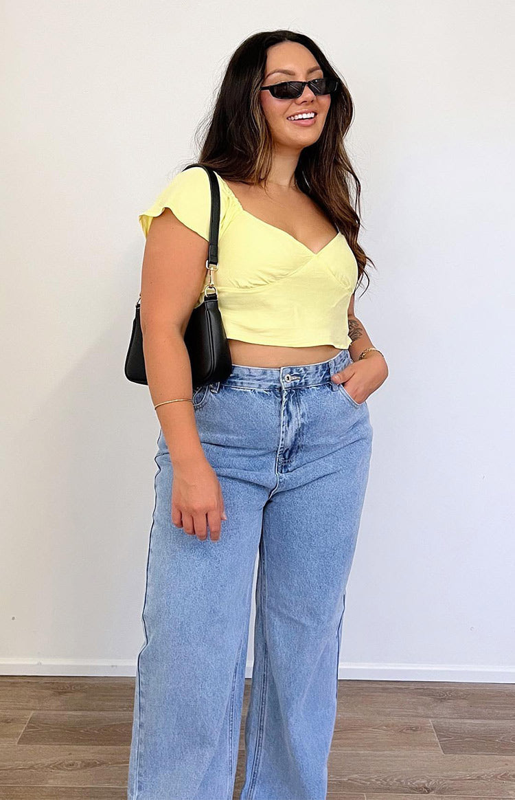 Yellow cropped top with a sweetheart neckline, gathered bust, and short flutter sleeves