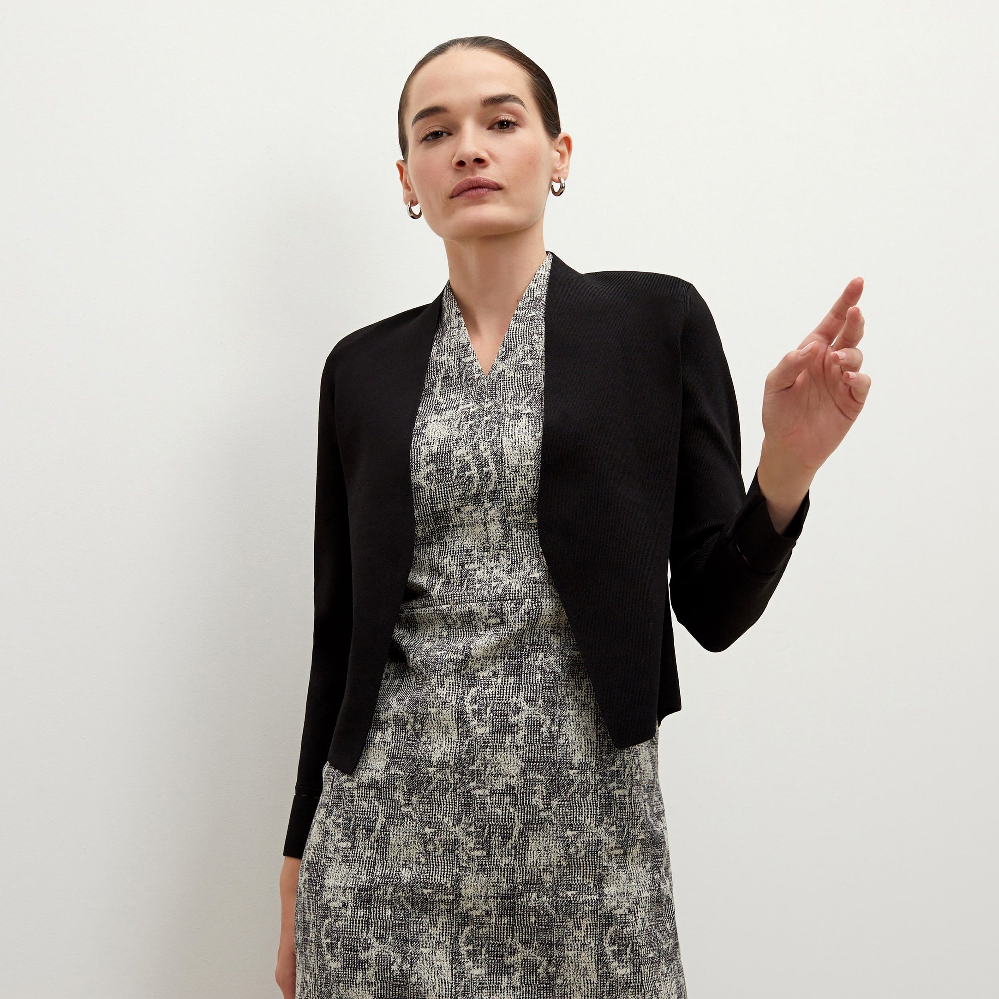 Front image of a woman standing wearing the Sant Ambroeus jardigan in black | Exclude