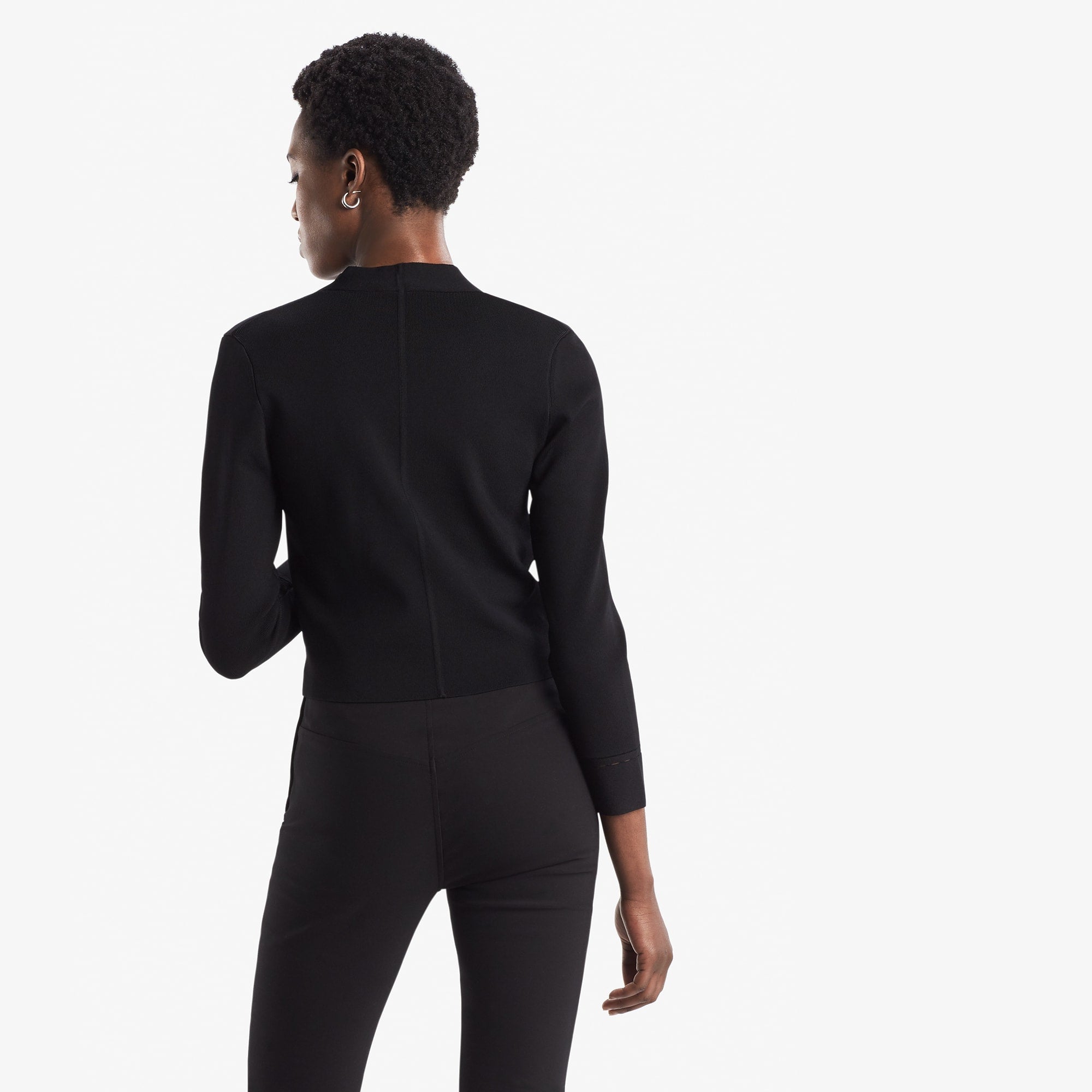 Back image of a woman standing wearing the Sant Ambroeus jardigan in black | Exclude